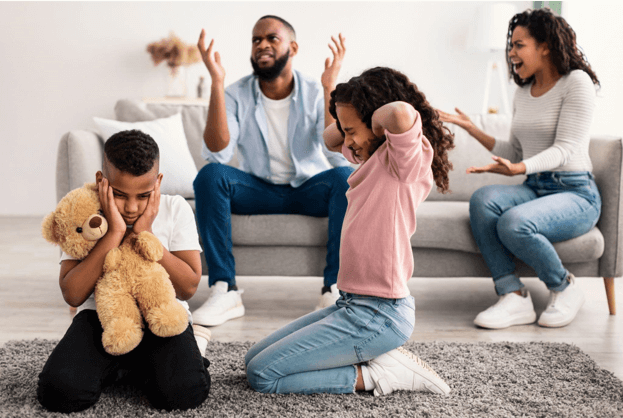 Cover image for Seasons of Change blog titled Managing Family Crises: Steps to Take When You Need Immediate Help. This picture shows a family arguing. The husband and wife are on the couch arguing and the daughter and son are sitting on a rug with their hands over their ears.