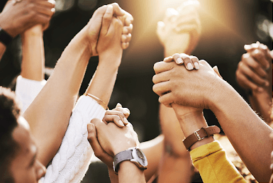 Healing from Trauma: Seasons of Change Inc.'s Supportive Community Programs featured image of hands up in the air holding each other to represent this community support program.