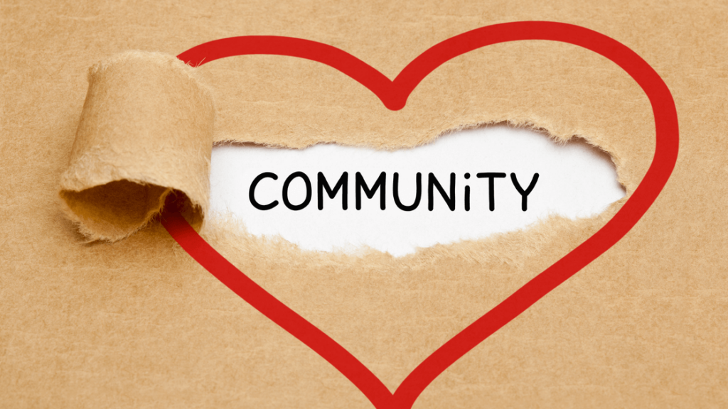 Community partnerships blog cover photo featuring a heart on brown paper with a rip revealing the work community.