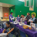 Arlington TX Community Resources: Families engage with vendors and information booths at the John Quincy Adams Resource Fair, supported by Seasons of Change Inc.